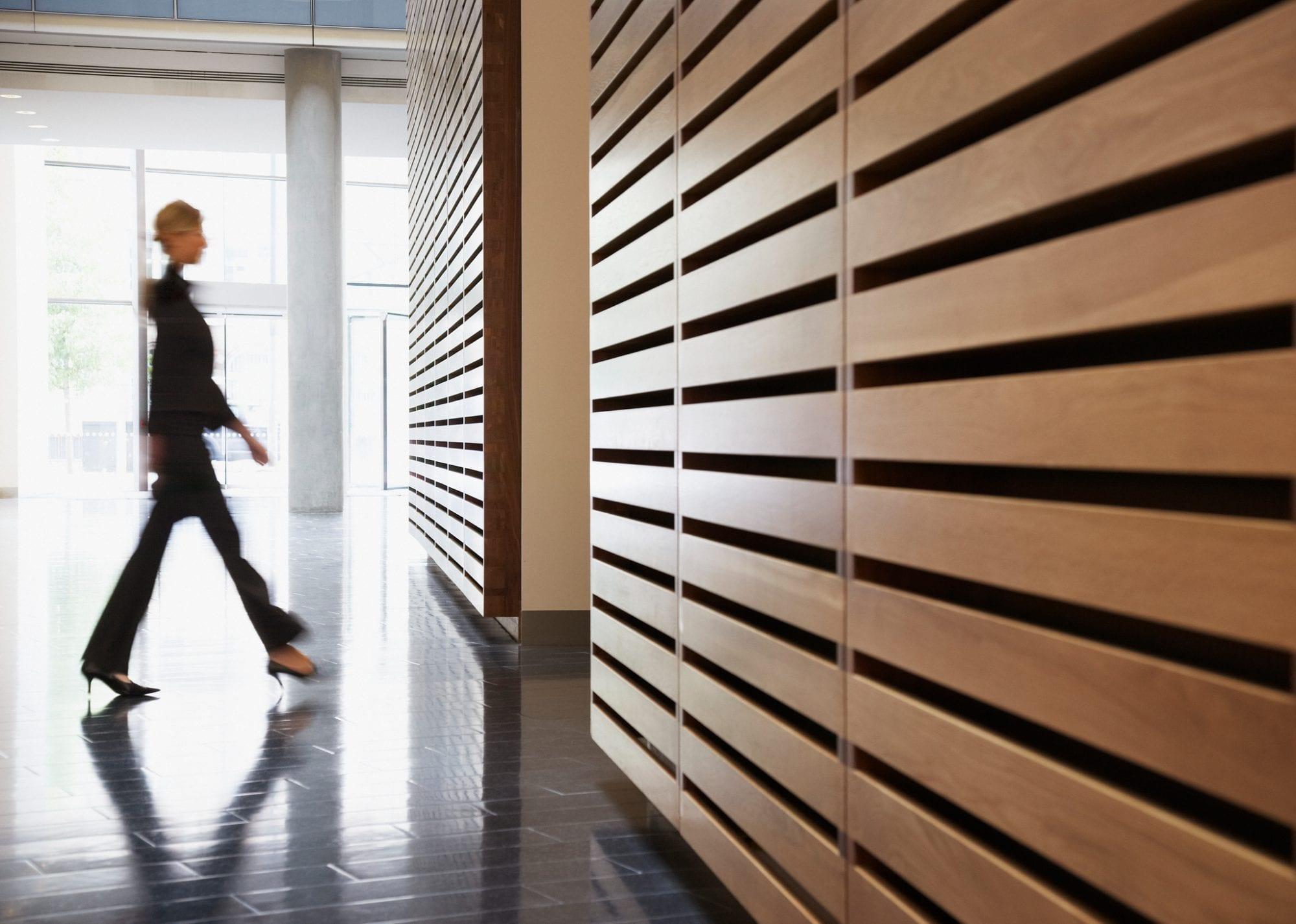 Office corridor with people moving between meeting rooms