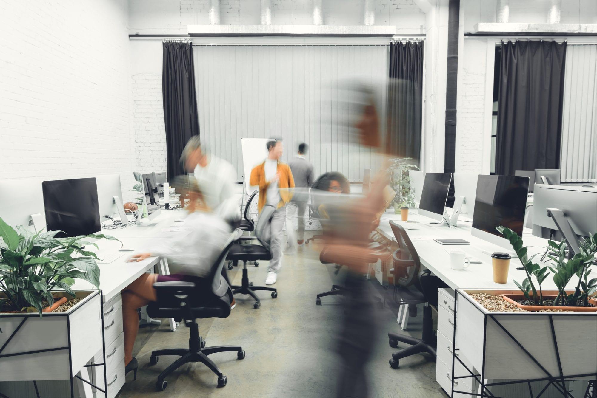 Open-plan office with staff working at their desks