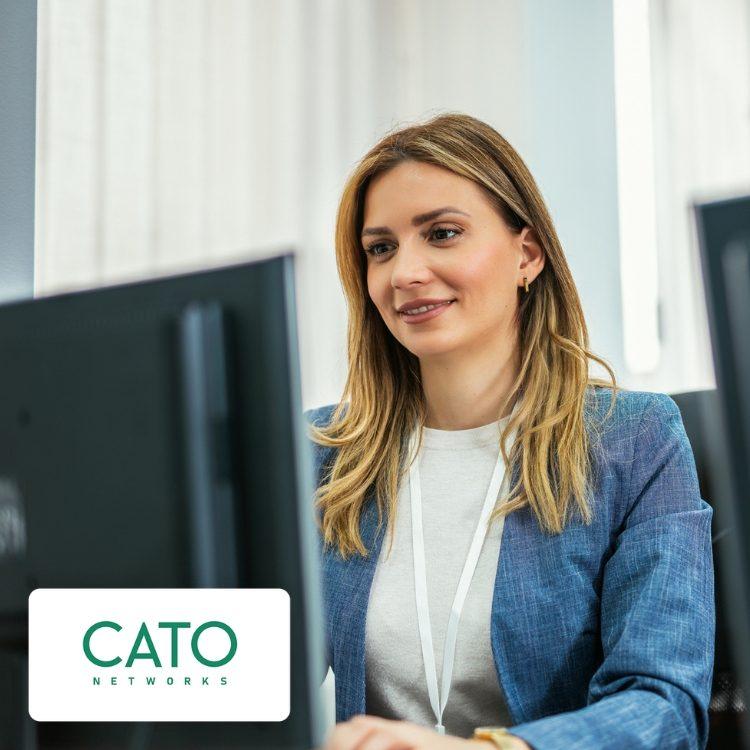 A woman working at a computer, with a Cato Networks logo in the corner